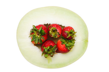 Melon Half with Strawberries isolated on White