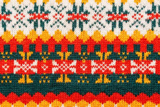 Motley christmas sweater texture with patterns. Colorful knit texture