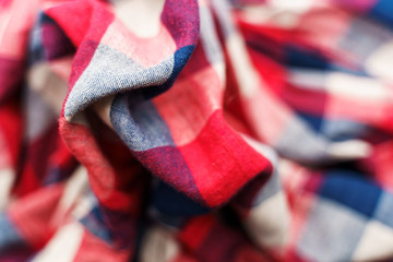 Plaid material texture. Red, blue and white cage clothes background