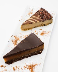 Chocolate Cheesecake Slices On A While Plate With A White Background