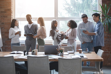 Friendly business team talking while having break