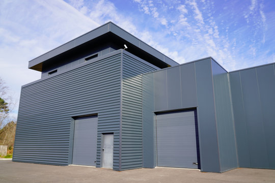 modern new grey warehouse hangar exterior with gray sectional gate