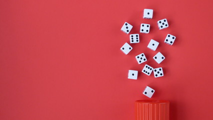 Flat Lay of Dice on a Red Background Spilling From a Red Cup | Game Night