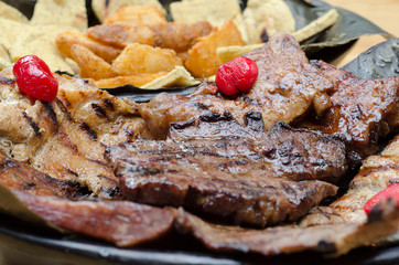  chopped variety of meats, cassava and arepa