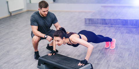 Personal trainer correct her client while doing push-ups. Healthy life and sport fit
