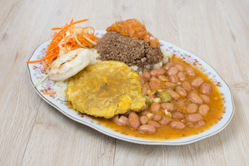 Colombian typical dish, beans, meat, rice, patacon egg