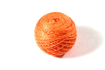 Ball of orange string on a white background.