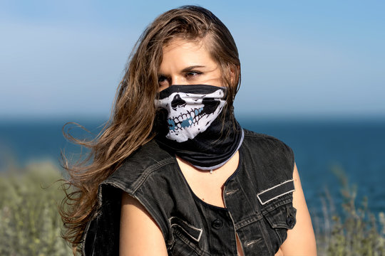 close-up portrait o woman in mask with stern look. Hot biker girl. beautiful women