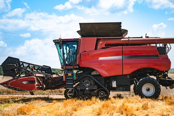 Combine harvester at work harvesting a field of wheat.