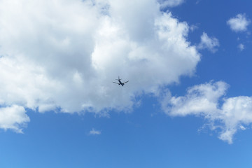 Plane is flying in cloudy sky