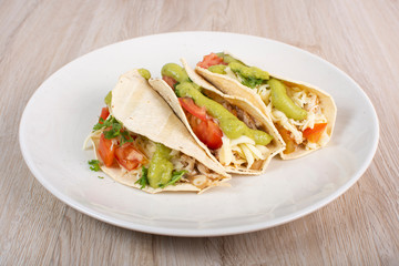 Mexican tacos with chicken, vegetables and guacamole