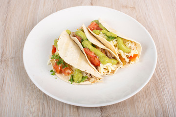 Mexican tacos with chicken, vegetables and guacamole