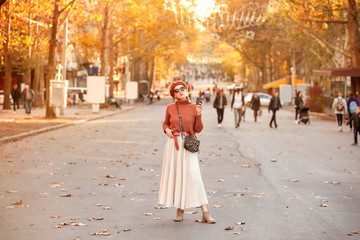 Portrait of fashionable young woman on city street