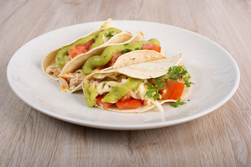 Mexican tacos with chicken, vegetables and guacamole