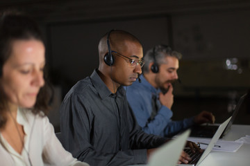 Thoughtful call center operators during working process. Confident client support team at workplace. Call center concept