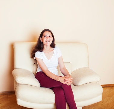 young pretty stylish woman at couch in home interior happy smiling, lifestyle people concept