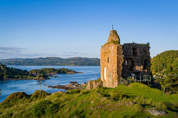 Ruins of Tarbert Royal Castle. Sunset light and panoramic view of the bay. Inner Henrides, Scotland.