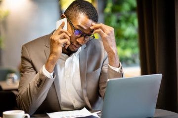 Portrait of focused afro businessman making phone call