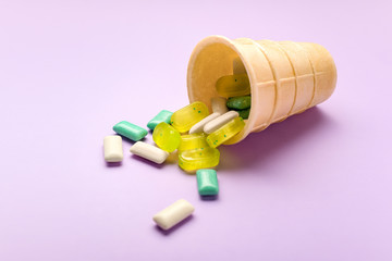 Wafer cone with different chewing gums on color background