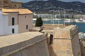 Fototapeta na wymiar Ibiza Castle at a coast with mountain and yachts view, Spain