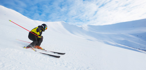 Alpine skier skiing in mountains