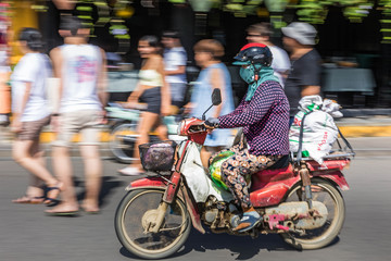 Panning motion shot of commuter in Hoi An, Vietnam.