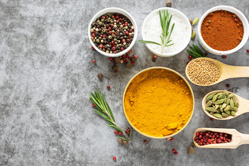 Aromatic organic spices and herbs on  dark concrete background with copy space for your text.