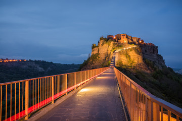 Light red trail leading at Blue hour at ghost town Civita di Bagnoregio in Lazio Italy at evening