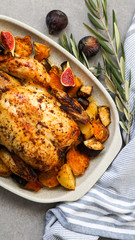 Roasted chicken with rosemary and  Sweet potato. served on grey stone, latin american food, top view
