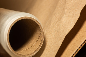 Roll of packaging film with paper in a cardboard box is macro
