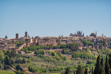 Fototapeta na wymiar Panoramic view of Orvieto small vilage in Italy with red brick houses and towers and nature in Umbria Italy
