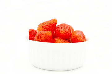 strawberries in a bowl isolated on white background