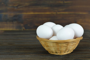 White chicken eggs in basket