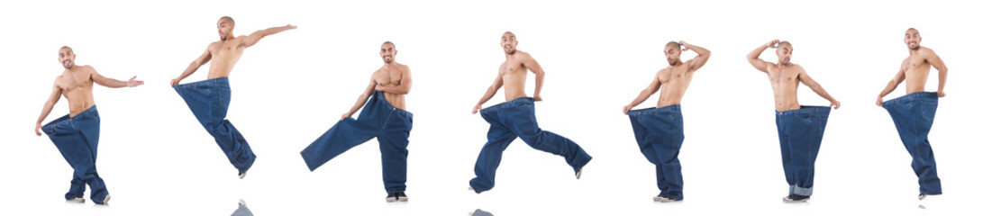 Man in dieting concept with oversized jeans