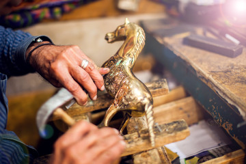 A man making embassed figure. Art and handwork industry