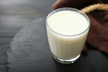 Glass of tasty on dark table