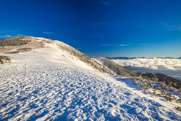 Winter mountain landscape at a sunny day with fog in the valleys. The Mala Fatra national park in Slovakia, Europe.