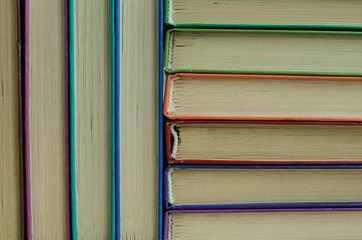 A stack of old books on a shelf.
