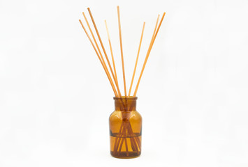 reed diffuser incense sticks in glass bottle isolated on white background