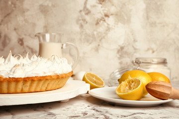 Tasty lemon pie on white table