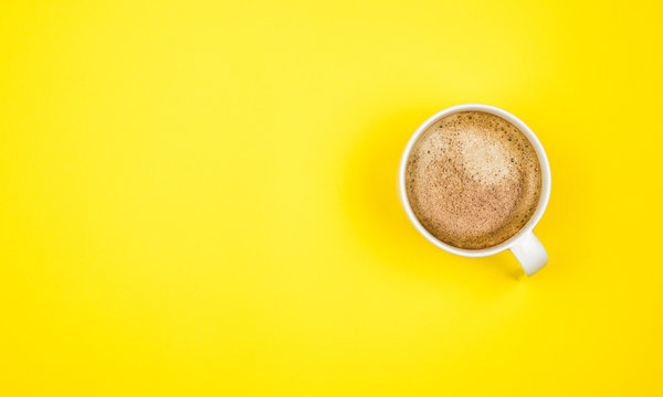 A Cup Of Black Coffee On Yellow Background. View From Above. Copy Space