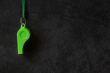 Green whistle of a sport referee or trainer, free copy space