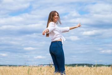 Young brunette woman in white shirt and blue jeans