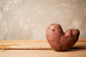 Ugly food, potatoes in the shape of a heart. Natural and simple farm products.