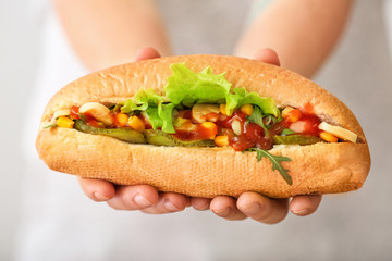 Woman with tasty hot dog, closeup