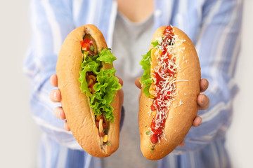 Woman with tasty hot dogs, closeup