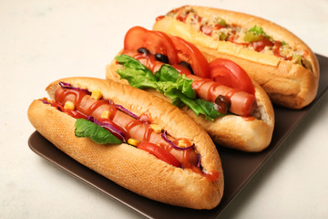 Tasty hot dogs on light background
