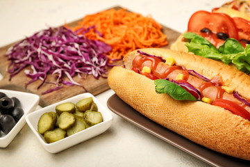 Tasty hot dogs on light background