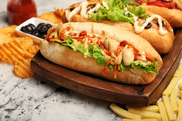 Tasty hot dogs on light background