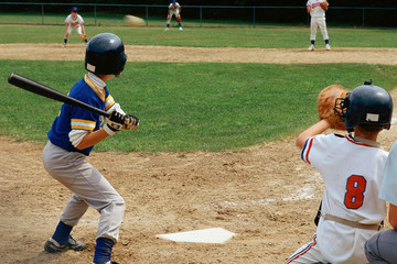 Young batter preparing to hit baseball